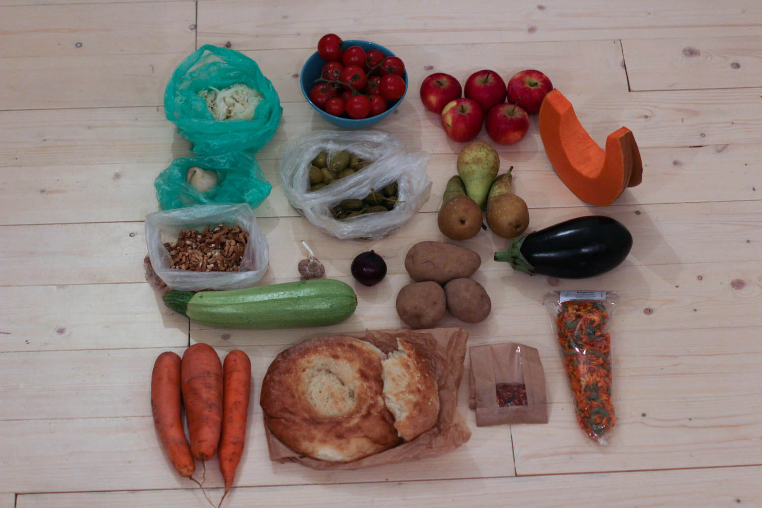 All the food we got at the Central Market. Carrots, Potatoes, a slice of a pumpkin, pickled garlic and lots more stuff.